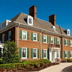 A brick building with green shutters